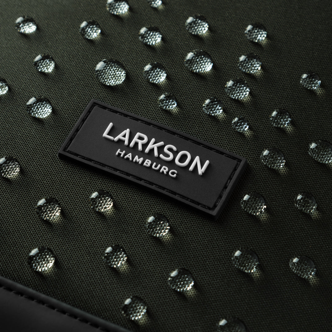 Nahe Ansicht des wasserabweisenden Stoffes mit 'LARKSON HAMBURG' Logo auf Rolltop Rucksack No 2