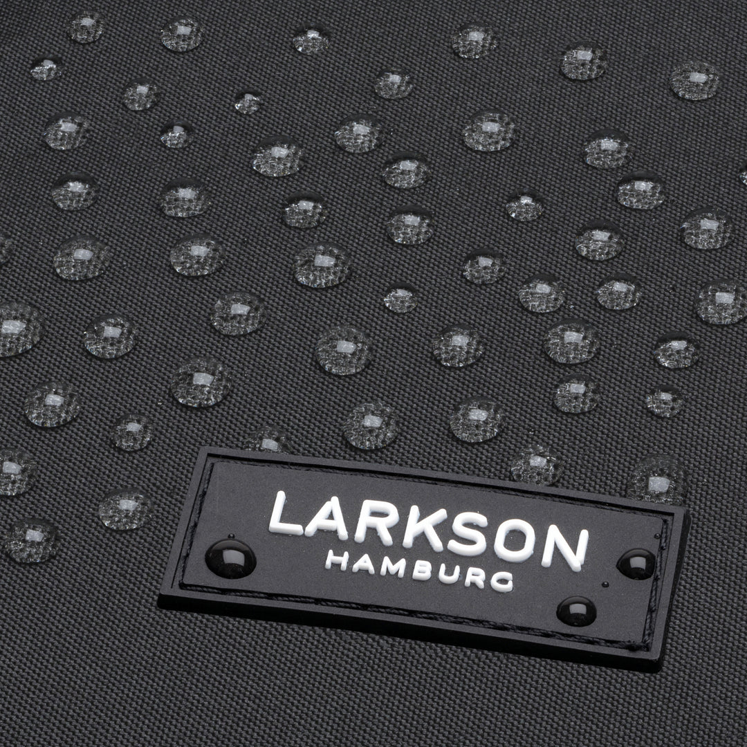 Nahaufnahme von wasserabweisendem schwarzem Gewebe mit LARKSON Hamburg Logo und Wassertröpfchen