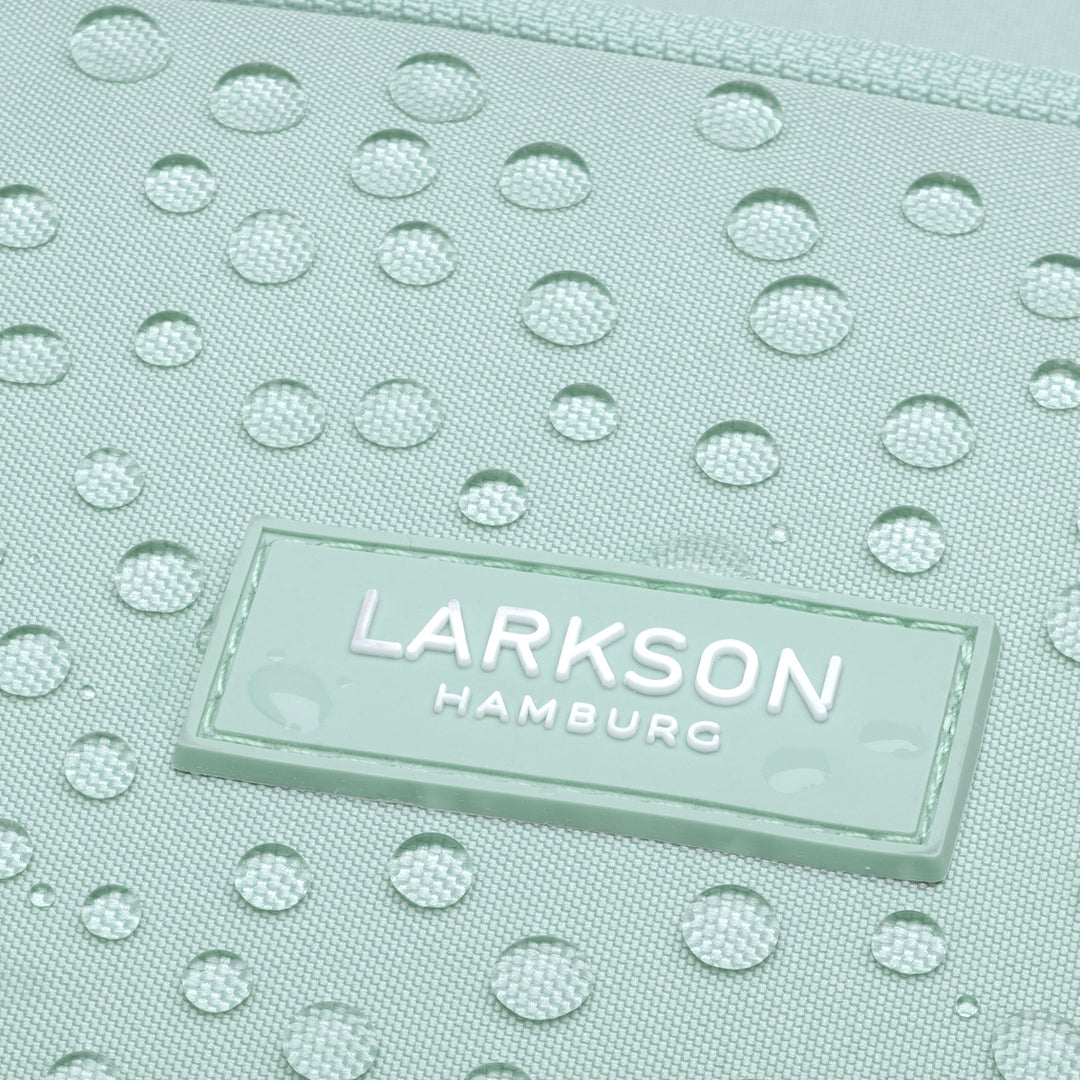 Nahaufnahme des wasserabweisenden, mintgrünen Stoffes des Rucksack No 6 mit LARKSON Hamburg Logo